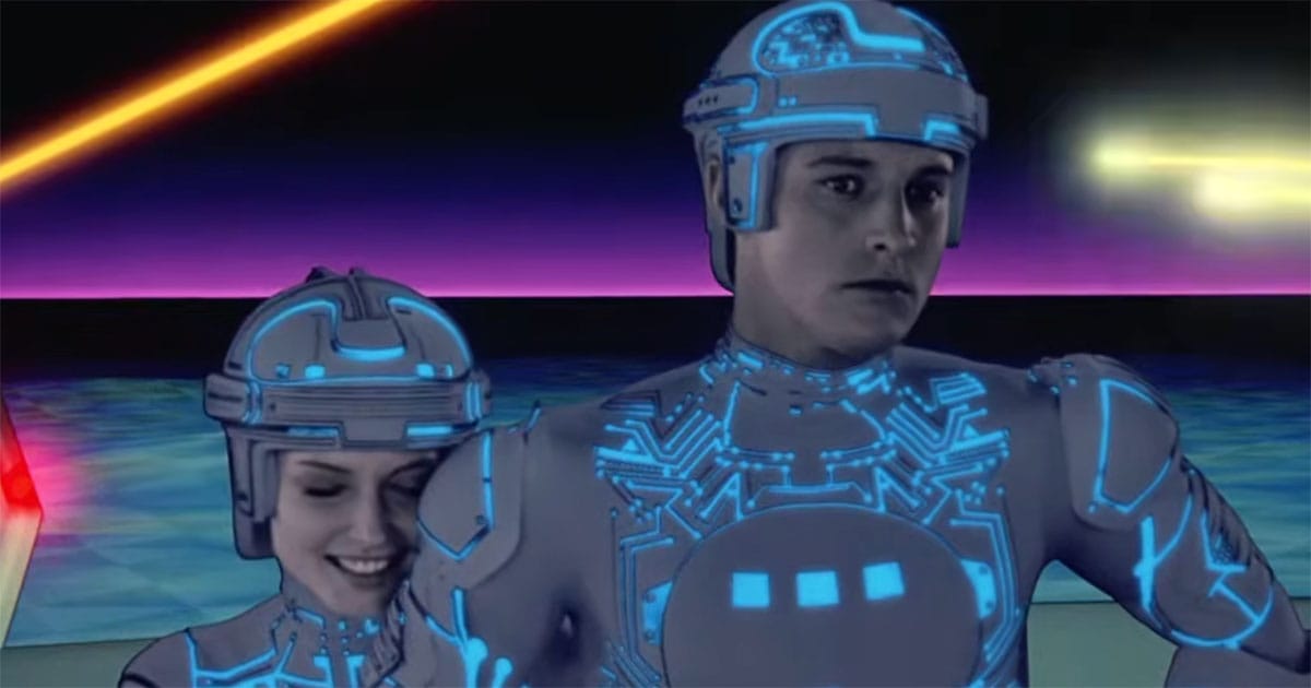 Tron and Yori stand together inside the Grid in the 1982 science fiction film "TRON," illustrating the film's humanized computer programs.