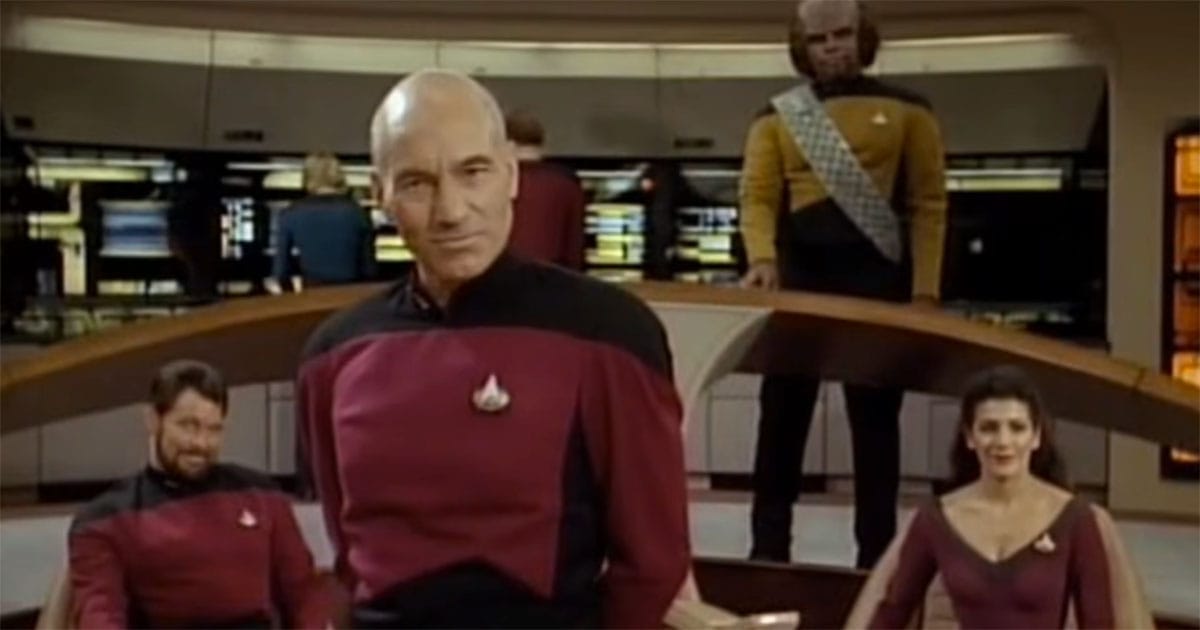 Captain Jean-Luc Picard stands on the bridge of the USS Enterprise with Commander Riker, Counselor Troi, and Lt. Worf in "Star Trek: The Next Generation."