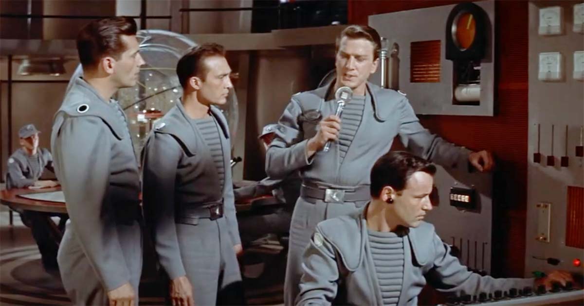 Crew members operate communications and control equipment aboard the spacecraft in "Forbidden Planet" (1956).