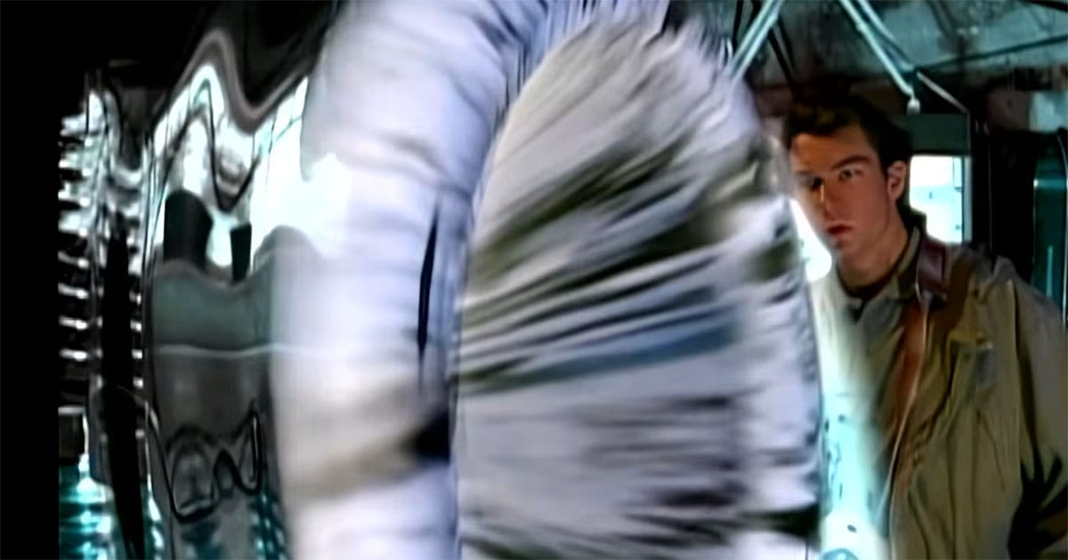 A man enters a swirling dimensional portal in a scene from "Sliders."