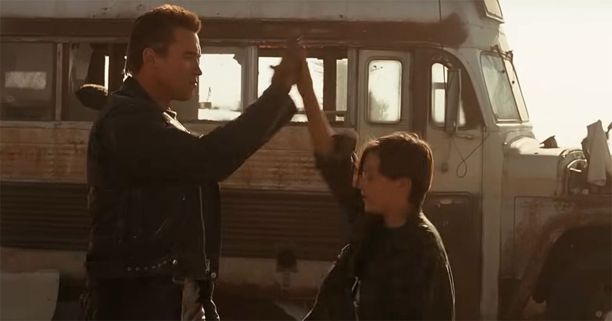 John Connor and the T-800 share a high-five.