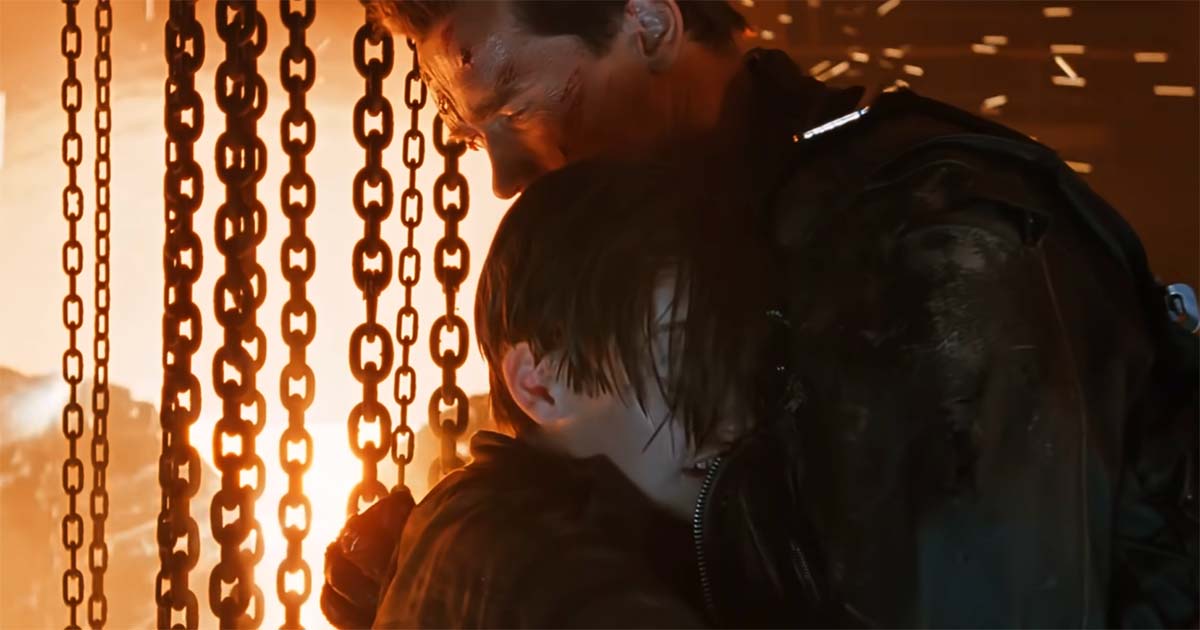 John Connor embraces the damaged T-800 in the steel mill.