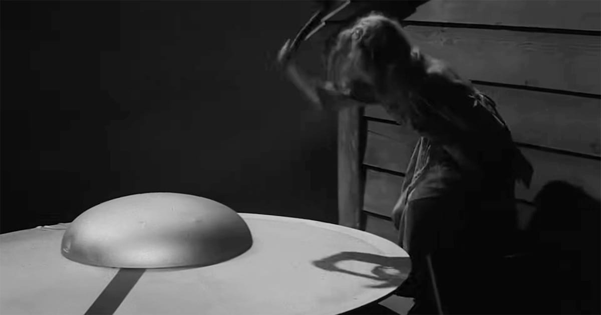 A woman confronts a large metallic object on a table in "The Invaders," an episode of "The Twilight Zone."