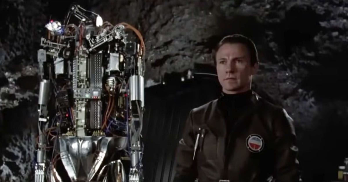 Hector, the experimental robot, standing beside Benson in "Saturn 3" (1980).