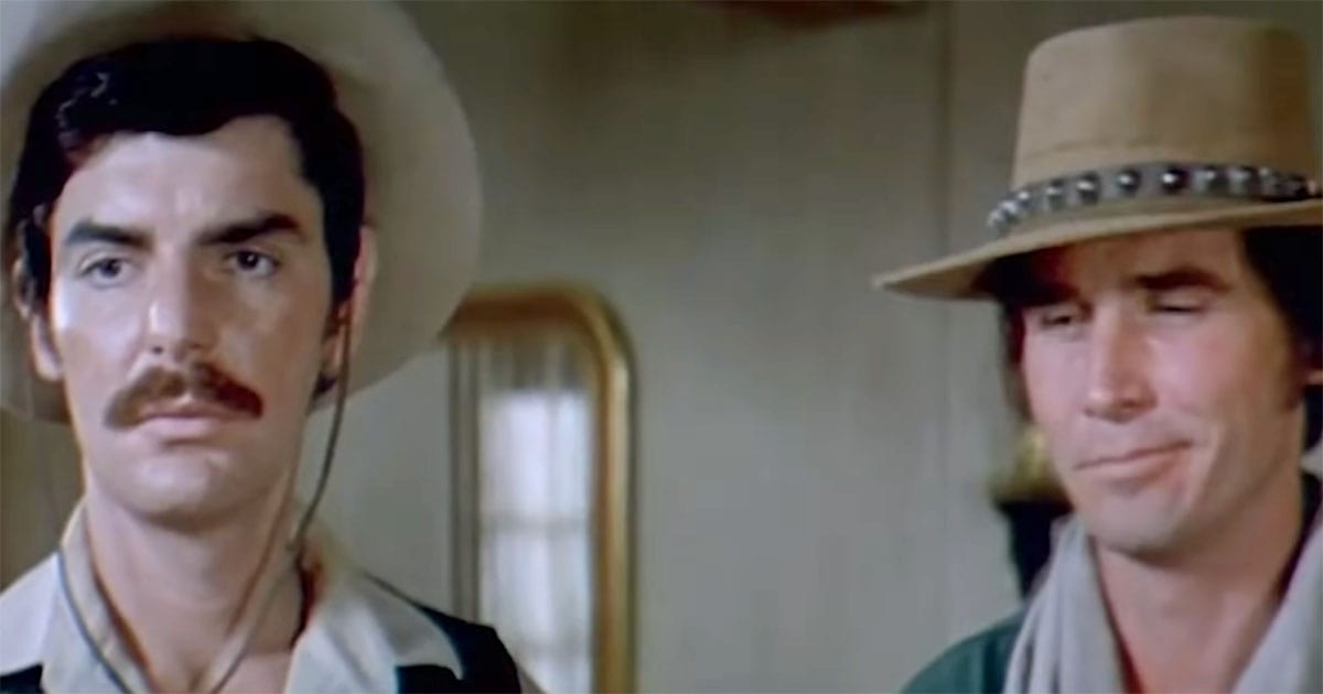 The robotic Gunslinger standing beside a human guest in "Westworld" (1973).