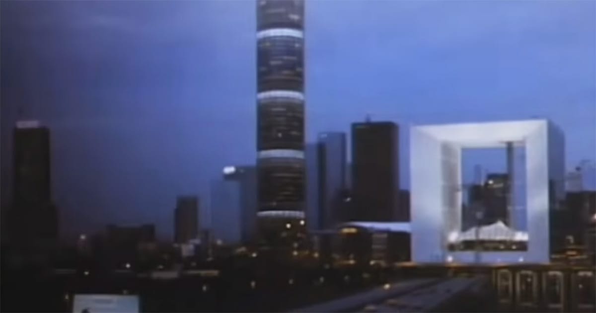 Futuristic city skyline at dusk in "Until the End of the World" (1991), with illuminated towers beneath a dark blue sky.