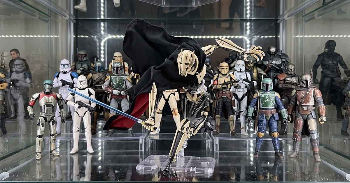 General Grievous action figure posed with a blue lightsaber in front of a display filled with Star Wars troopers, bounty hunters, and armored figures.