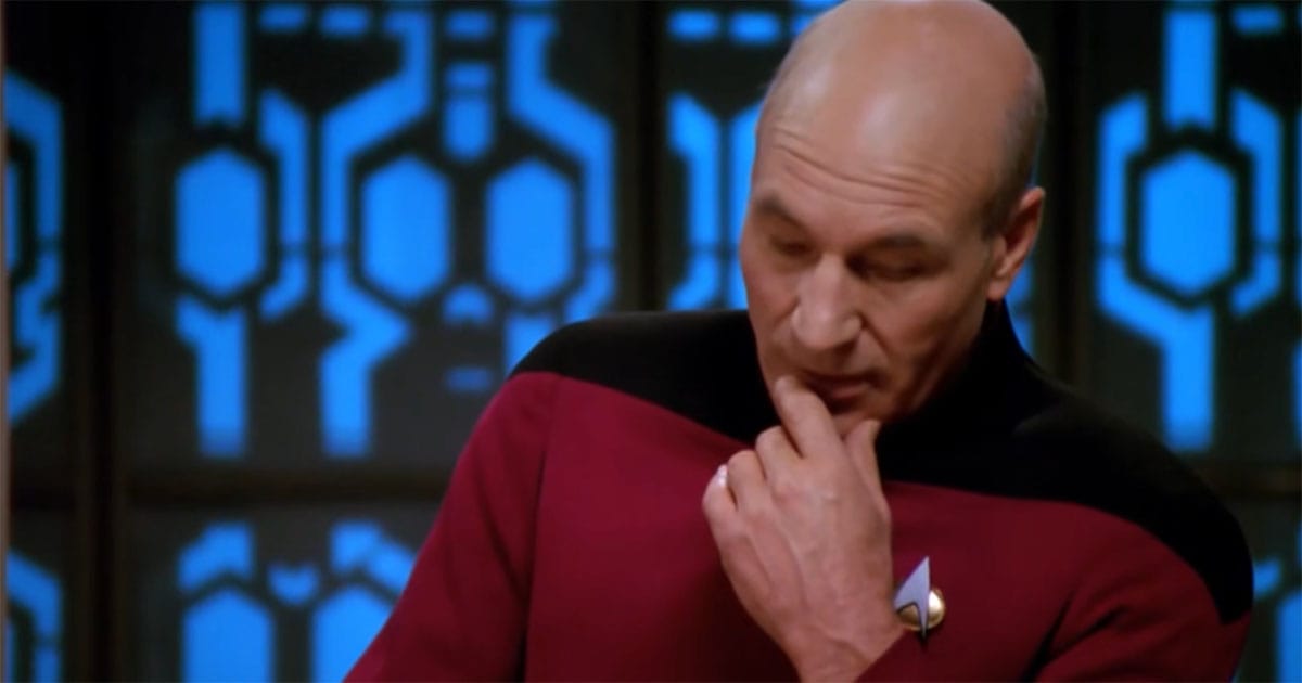Jean-Luc Picard sits in thoughtful reflection aboard the Enterprise.