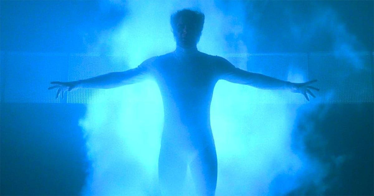 A silhouette of a man surrounded by bright blue light.