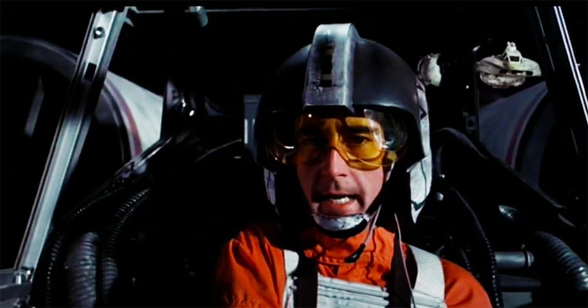 Denis Lawson in full X-wing pilot gear as Wedge Antilles, seated in the cockpit during a "Star Wars" battle scene