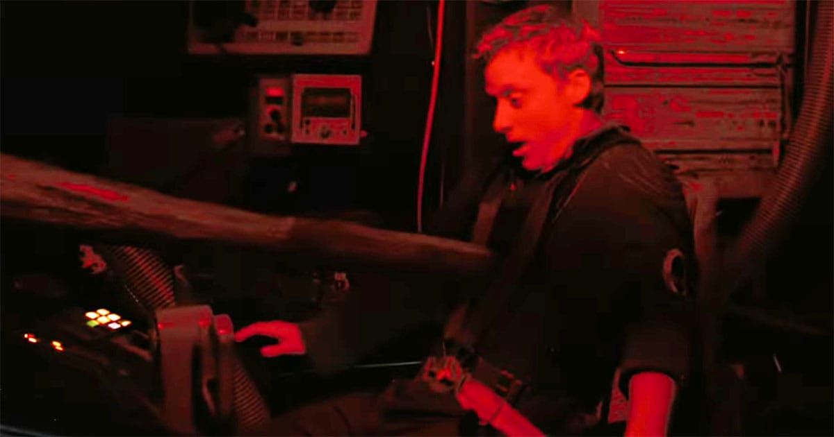 Hoban Washburne impaled by a harpoon in the cockpit during a red-lit emergency scene from "Serenity" (2005)