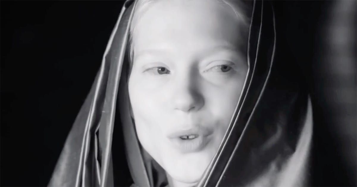 Black-and-white close-up of Lady Margot Fenring in a Bene Gesserit veil, her expression calm and observant, suggesting quiet authority within the imperial court.