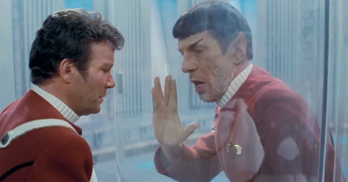 Leonard Nimoy as Spock touching glass with Captain Kirk in a solemn Star Trek scene