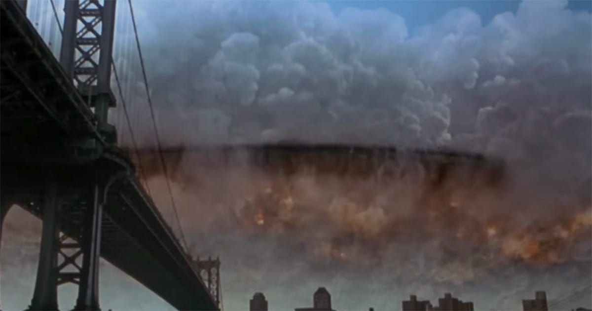 Alien mothership hovering above a city as a massive explosion spreads beneath it in "Independence Day"