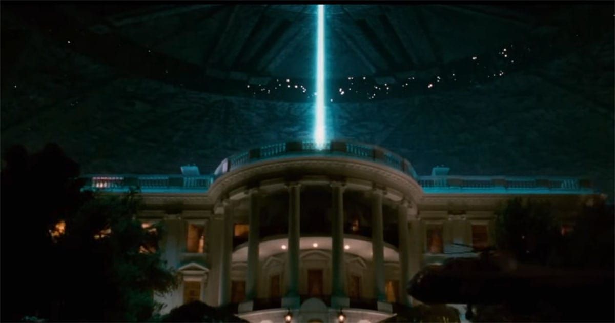 A giant alien spacecraft hovers above the White House in a scene from the 1996 science fiction film "Independence Day," with a blue energy beam shining down from the ship.