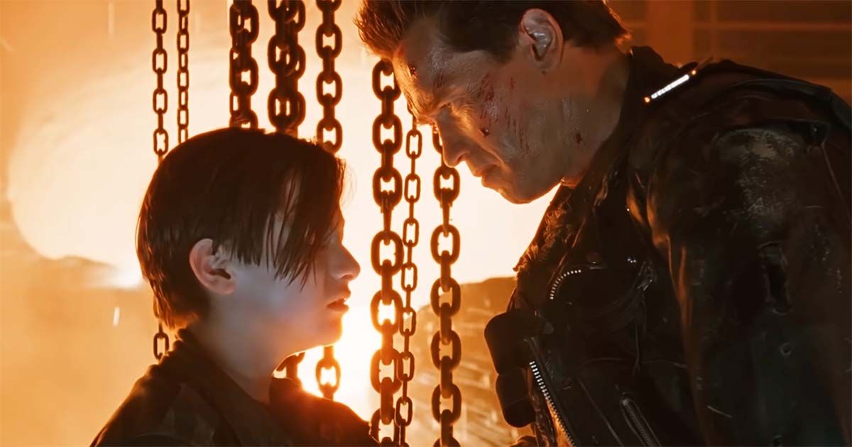 John Connor embraces the damaged T-800 in the steel mill.
