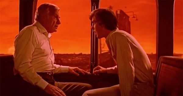 Alex Gardner and the President talk inside a train with a fiery red dreamscape outside in Dreamscape (1984).