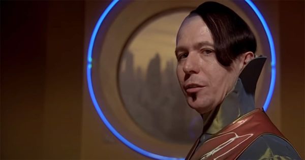 Zorg (Gary Oldman) gazes sideways in his high-tech office, backlit by a glowing blue circle in "The Fifth Element."