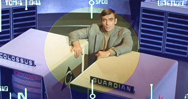 A screen capture showing the Dr. Forbin character between monitors for two AIs.