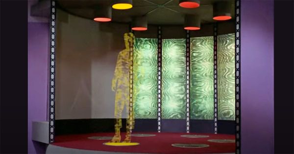 Classic "Star Trek" transporter sequence showing a crew member mid-dematerialization aboard the USS Enterprise.