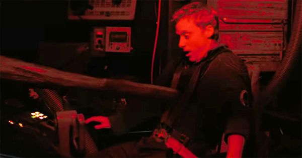 Hoban Washburne impaled by a harpoon in the cockpit during a red-lit emergency scene from "Serenity" (2005)