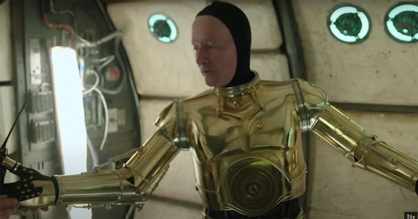 Anthony Daniels wearing the rigid C-3PO suit without helmet on a Star Wars set showing the challenging costume design
