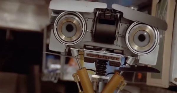 Close-up of Johnny 5 from "Short Circuit" with a tilted head and expressive eyes.