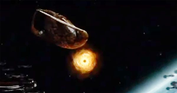 Still from "Farscape" showing Moya escaping toward a wormhole while Peacekeeper ships close in from orbit.