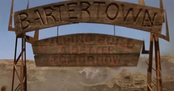 Wooden sign reading Bartertown at the entrance of the desert settlement in Mad Max Beyond Thunderdome