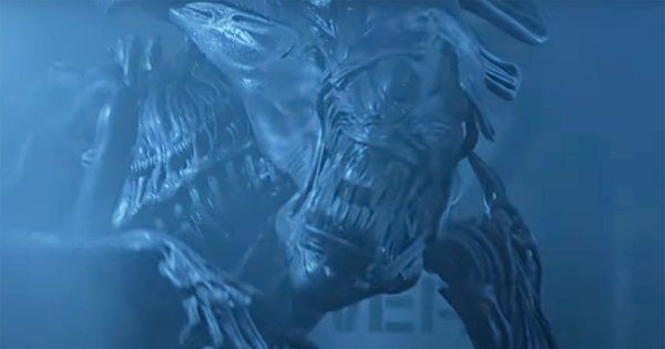 Alien Queen lunging in blue-lit scene from Aliens 1986 as she attacks Ripley and Newt