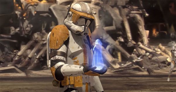 Clone Commander Cody holding a blue hologram of Darth Sidious delivering Order 66 amidst battlefield wreckage in "Star Wars: Episode III – Revenge of the Sith"