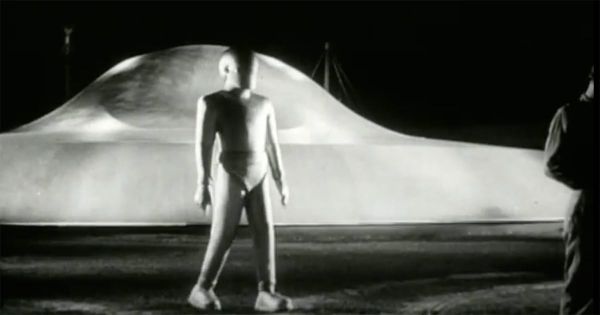 Gort the robot standing in front of the landed flying saucer at night in The Day the Earth Stood Still (1951)