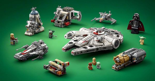 LEGO Star Wars Millennium Falcon with X-Wing, Star Destroyer, R2-D2, Grogu, Darth Vader, and other ships on green background.
