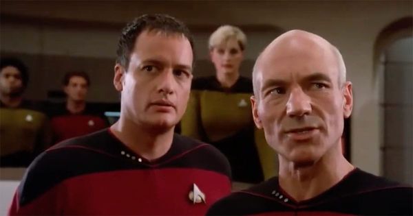 Captain Picard and Q stand on the bridge of the Enterprise in Star Trek: The Next Generation, during the events of “Encounter at Farpoint.”