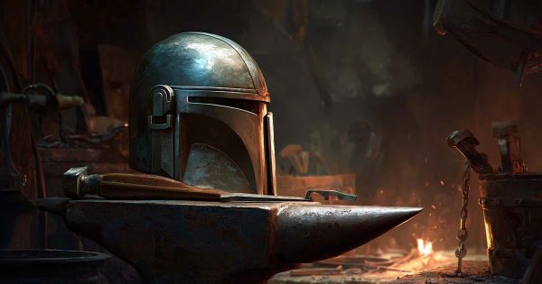 Close-up of a Mandalorian helmet resting on an anvil in a forge.