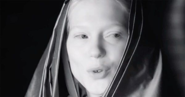 Black-and-white close-up of Lady Margot Fenring in a Bene Gesserit veil, her expression calm and observant, suggesting quiet authority within the imperial court.