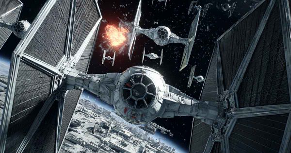 Imperial TIE Fighter charging into battle without deflector shields as another fighter explodes behind it.