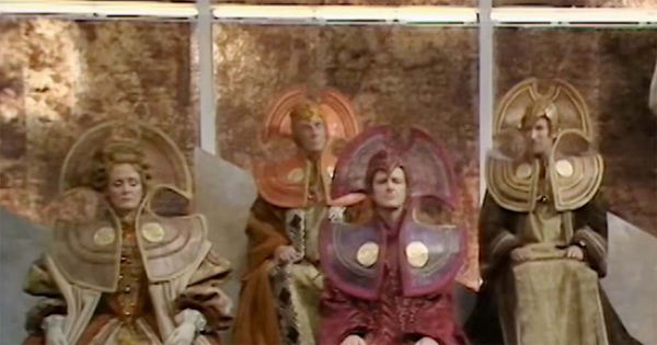 Time Lords in ceremonial robes and headpieces on Gallifrey in Doctor Who High Council scene.
