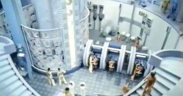 Futuristic interior of the World State facility in "Brave New World" (1980) showing controlled environment and structured society.