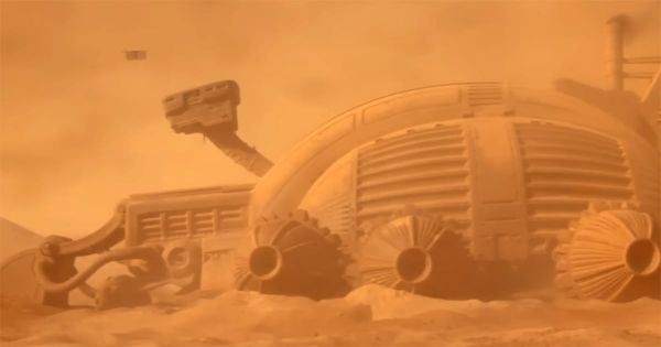 Large spice harvesting machine operates in a dust-filled desert on Arrakis.
