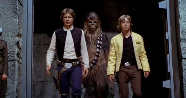 Han Solo, Chewbacca, and Luke Skywalker walk together in a scene from "Star Wars: A New Hope."