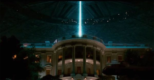 A giant alien spacecraft hovers above the White House in a scene from the 1996 science fiction film "Independence Day," with a blue energy beam shining down from the ship.