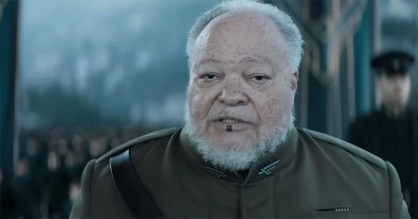 Thufir Hawat from "Dune" wearing an Atreides uniform with the characteristic Mentat lip mark visible.