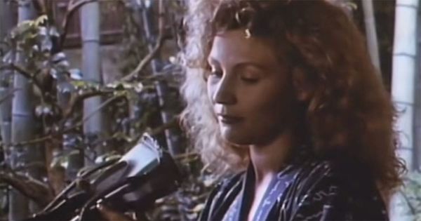Claire Tourneur examines a handheld recording device in "Until the End of the World" (1991).
