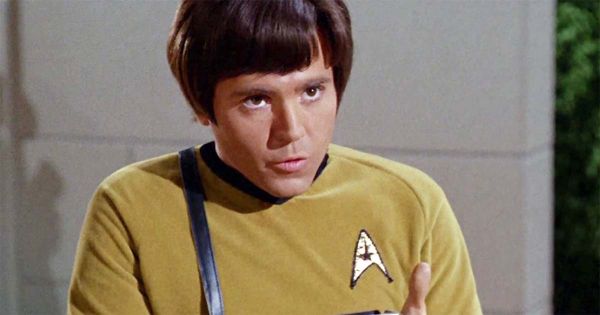 Walter Koenig as Pavel Chekov, looking upward in a gold Starfleet uniform in the original “Star Trek.”