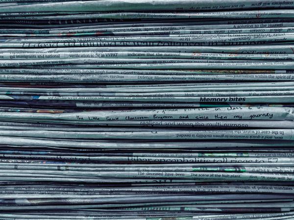 Close-up of a stack of newspapers.