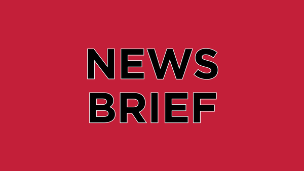 Black text on red backgound reads: NEWS BRIEF.