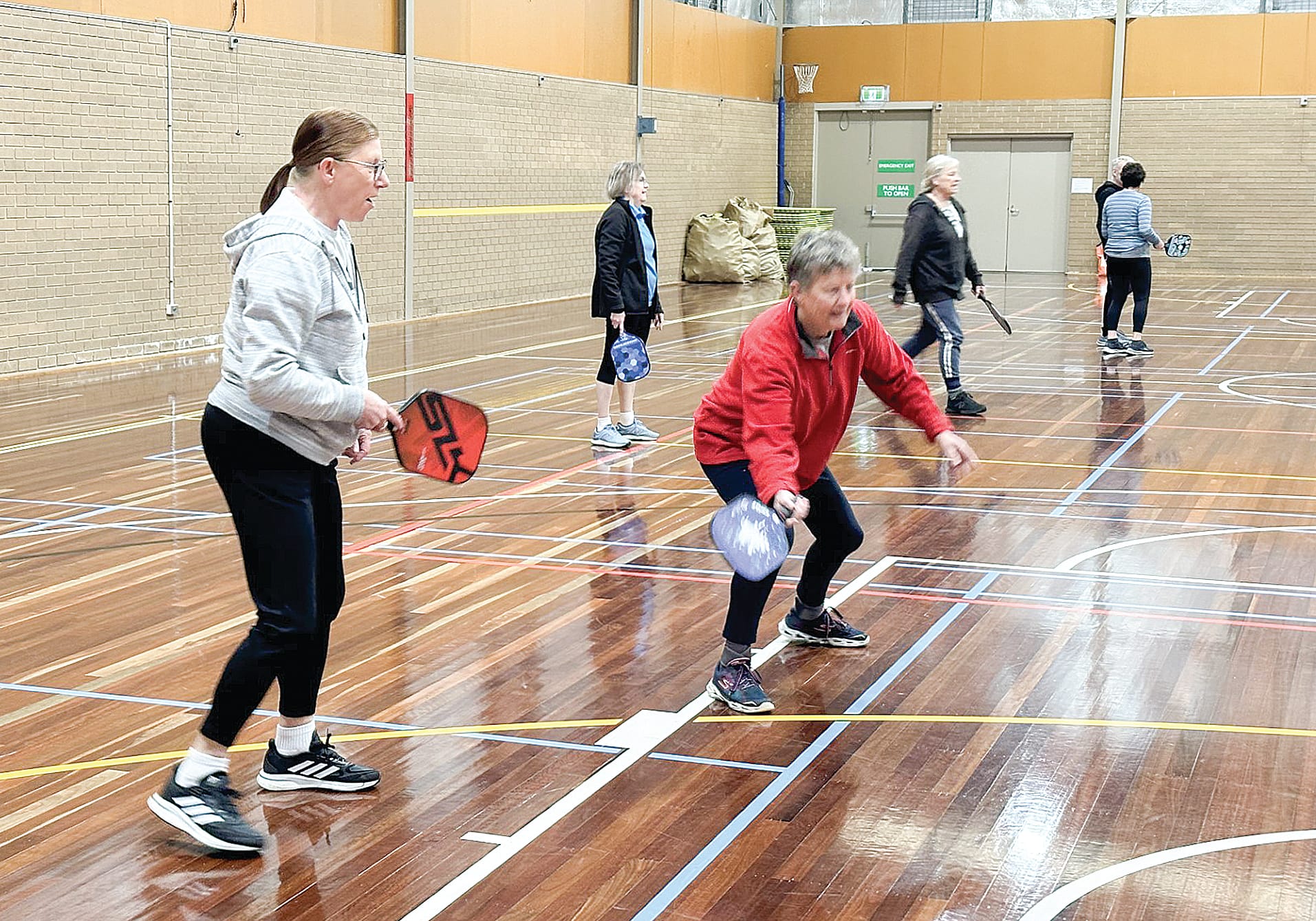 Louise Dickson, from Inverloch fell in love with the sport after just one game, watching on as team mate Sue Whyte returns the ball. ob07_3723