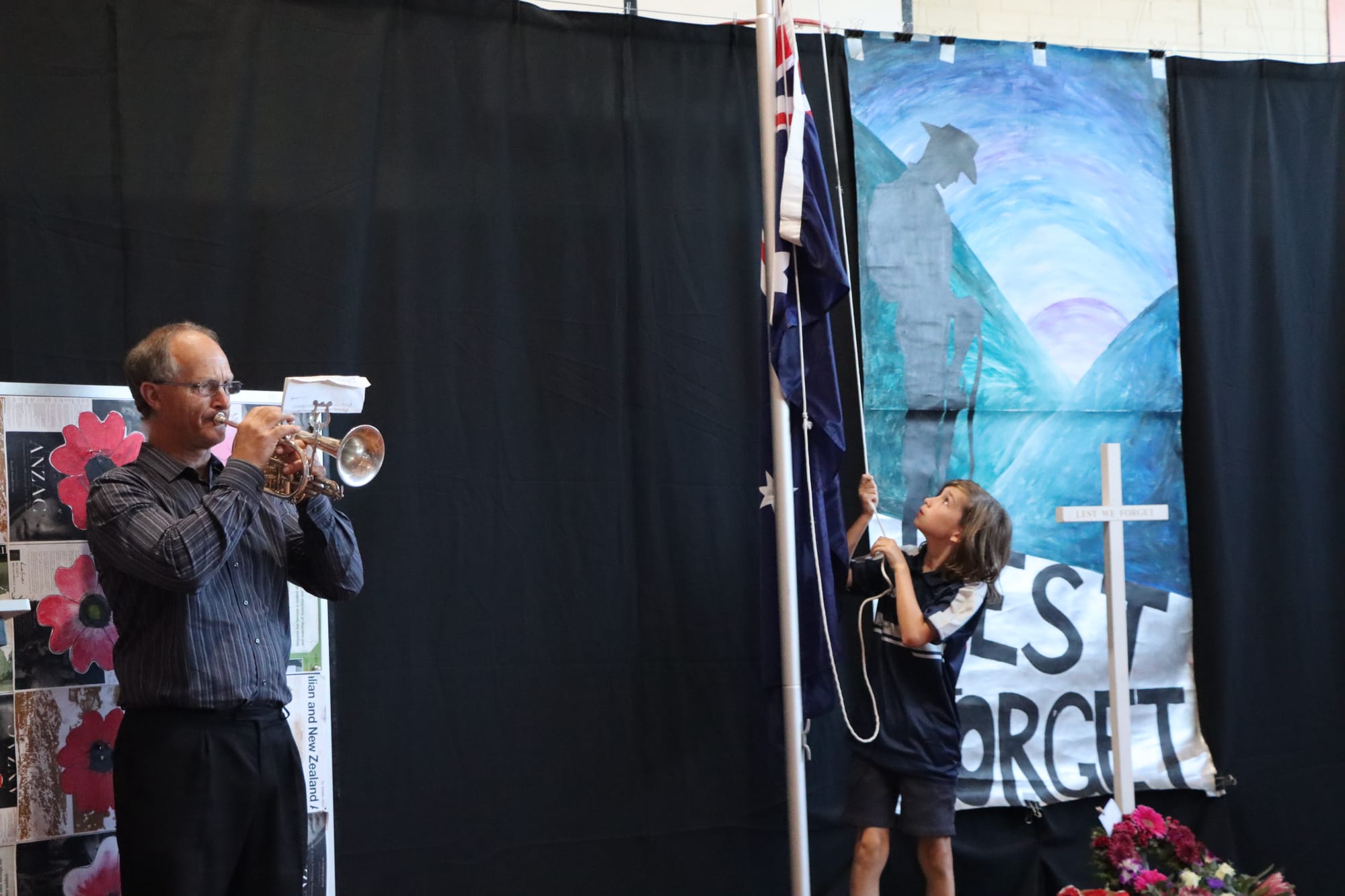 Phil Richards plays The Last Post, with student Ryan in charge of the Australian flag.

