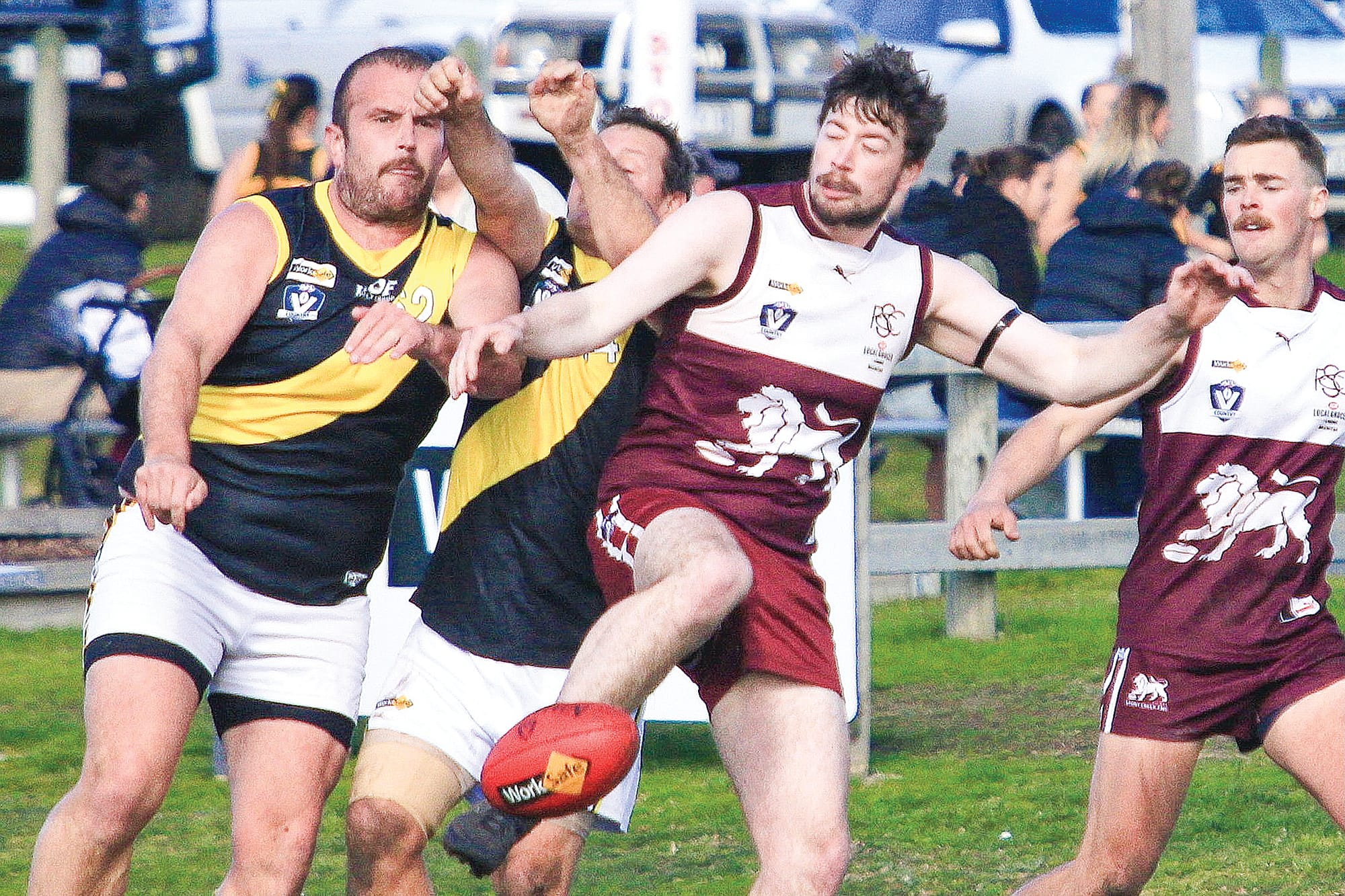 Stony Creek manages a kick with Mirboo Tigers on his tail. Photo: G.S. Bruning